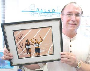 n this file photo, BALCO founder Victor Conte holds up an autographed photo addressed to himself of track star Marion Jones in his office in Burlingame, Ca. Conte pleaded guilty to conspiracy to distribute steroids and money laundering.
